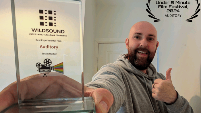 Justin Walker with award for Auditory