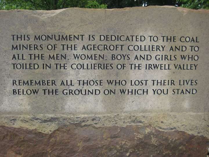 Stone memorial plaque with inscription honoring coal miners of Agecroft Colliery and those who died underground in the Irwell Valley.