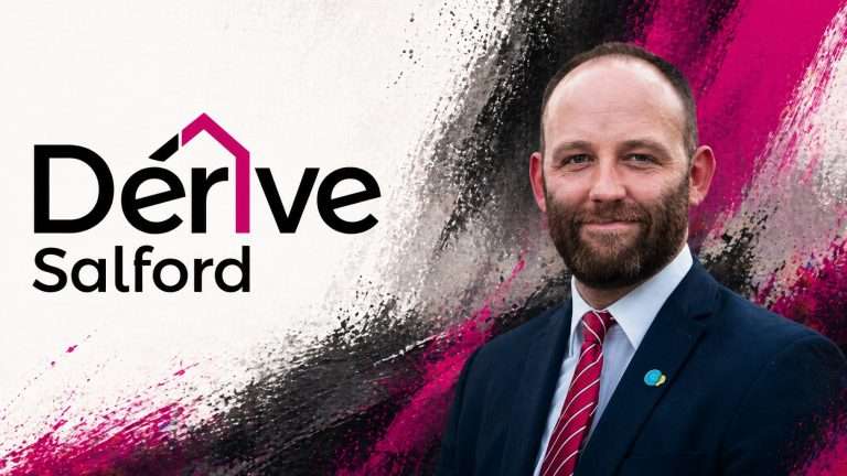 Portrait of a man in a navy suit and red striped tie, standing in front of a magenta/black brushstroke background with the 'Dérive Salford' logo